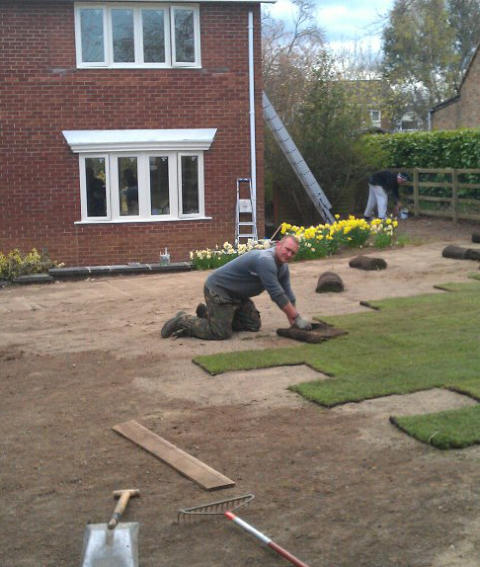 Header image - Gardener laying turf